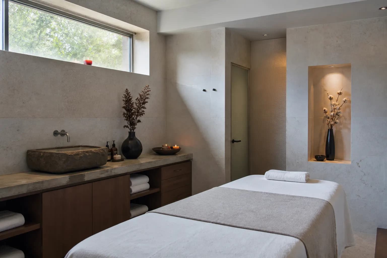 Quiet spa treatment room with stone basin